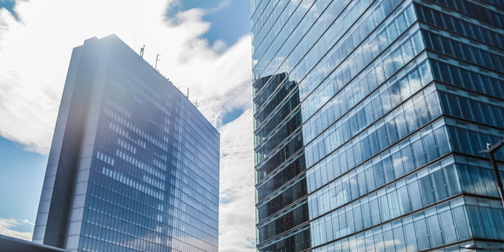 Exterior view of buildings with clouds reflected in their windows